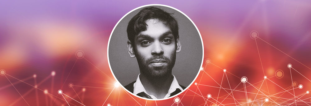 Headshot of Sanjay Saverimuttu against plain background